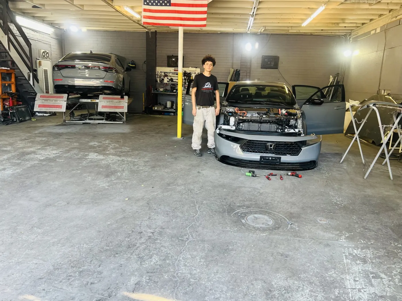 Honda undergoing front-end collision repair in the shop